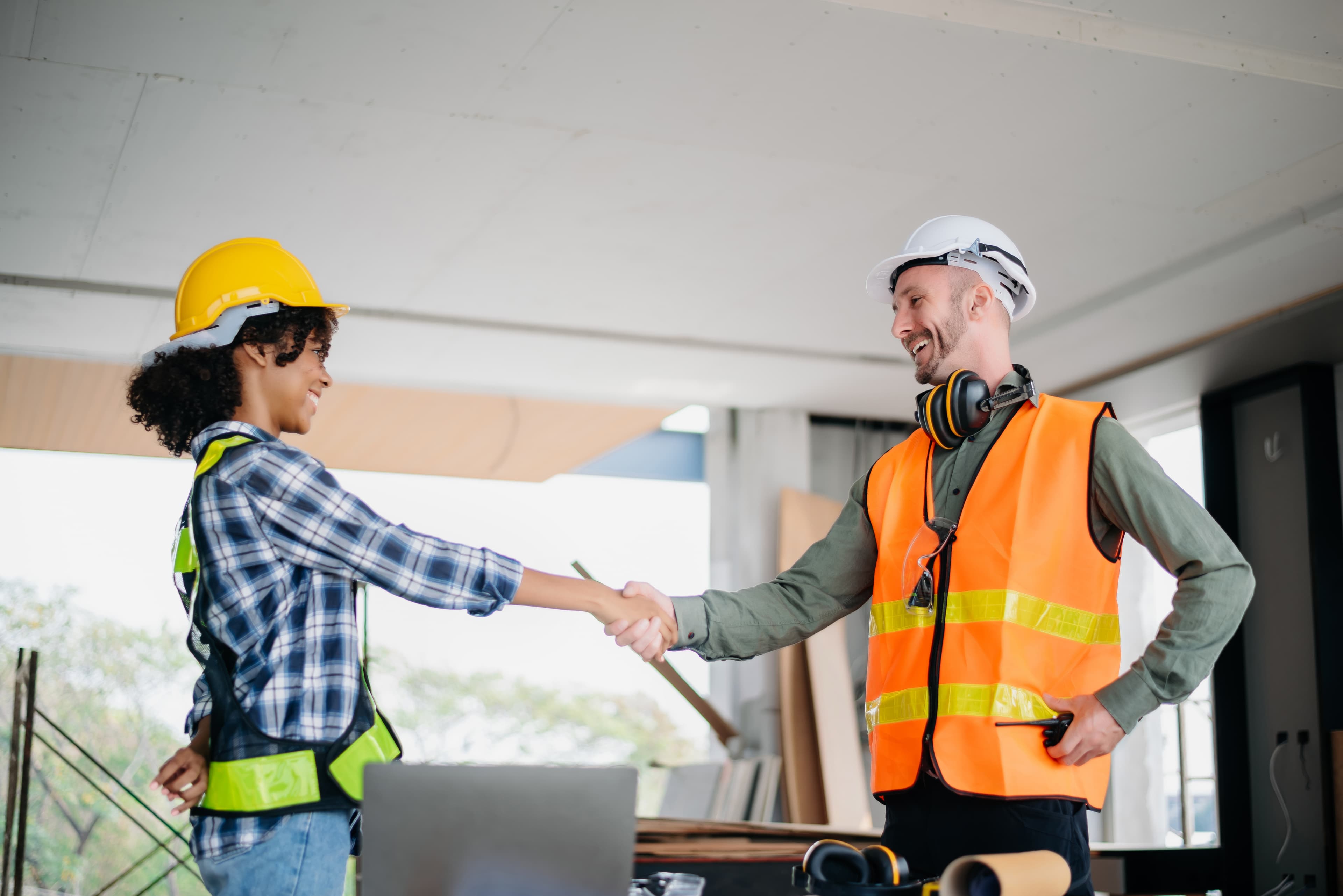 Construction team shaking hands on a building project